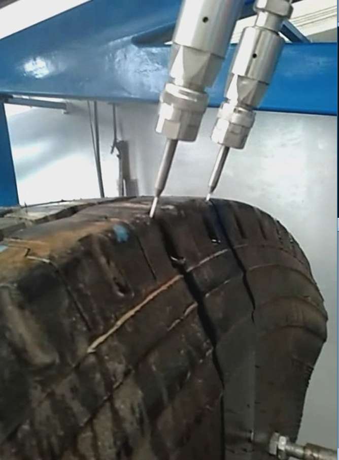 waterjet cuts a strip of tire